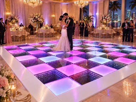 Bride and groom dancing on a pink and purple LED mirror infinity dance floor rental in Miami